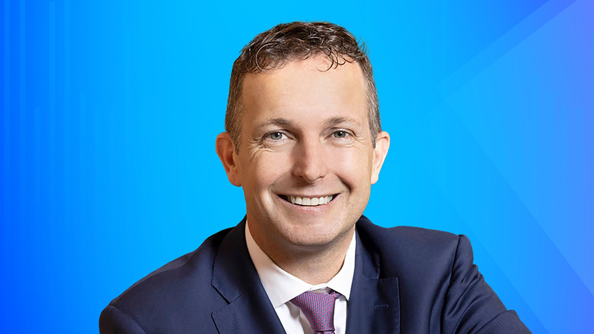 Head and shoulders Nigel Fitzgerald against blue gradient background