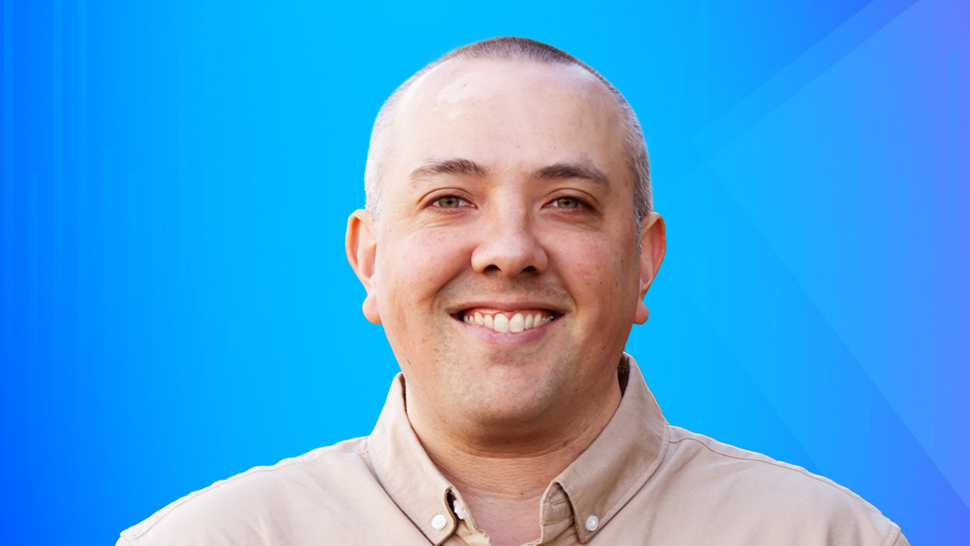 Head and shoulder shot of Jonathan Lam against blue background